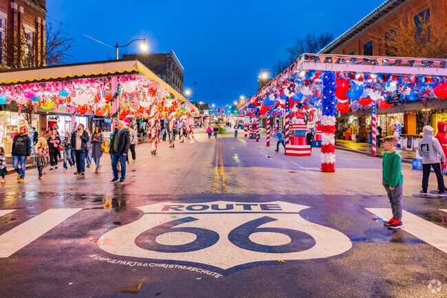 A grand historical Route 66 sign is featured alongside The Route 66 Christmas Chute show.
