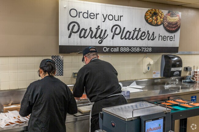 Workers prepare deli platters at Shaw's near Braintree Highlands.