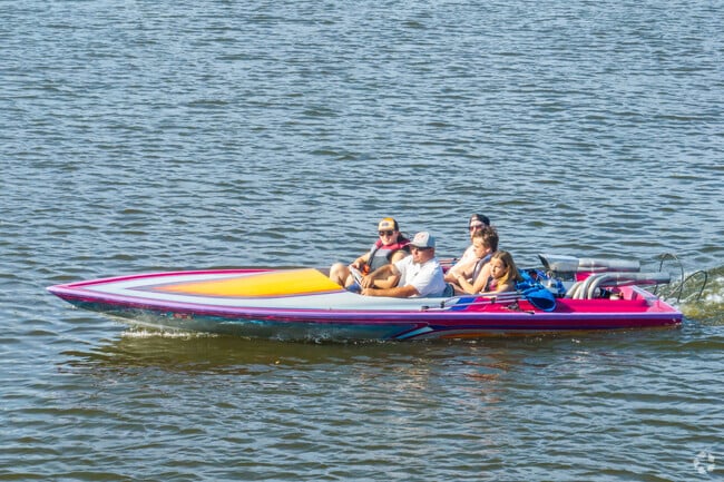 A family enjoys boating in Lake Elsinore, where Lake Edge residents have access to its various water recreation.