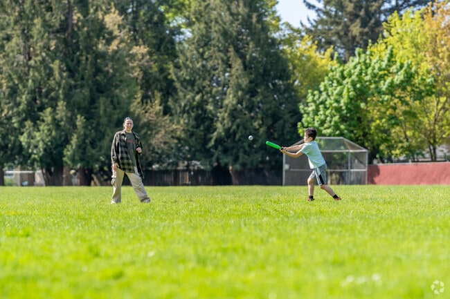 Families enjoy playing baseball on the field at Claggett Creek Park in Keizer.