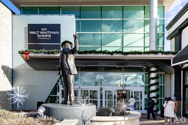 A statue of Walt Whitman marks the entrance of Walt Whitman Shops in South Huntington.
