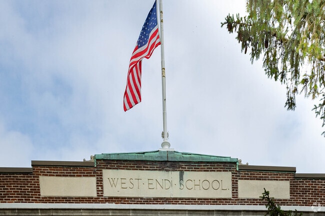 A flag flies high on top of the West End School in Lynbrook, NY.