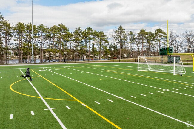 A person practices their soccer kicks at the football field at Quinsigamond State Park, near Hamilton.