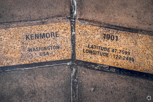 Kenmore sign and geographical detail on a sidewalk sign in Downtown Kenmore.