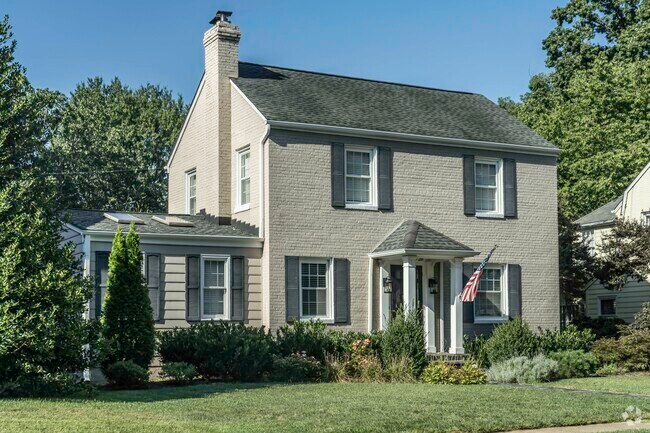 This classic brick home in Willow Lawn features lush landscaping.
