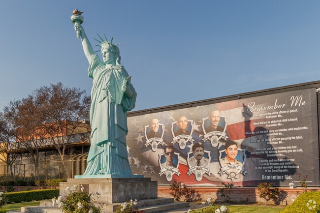An impressive replica of the Statue of Liberty stands in front of the Police Memorial at the El Monte Civic Center.