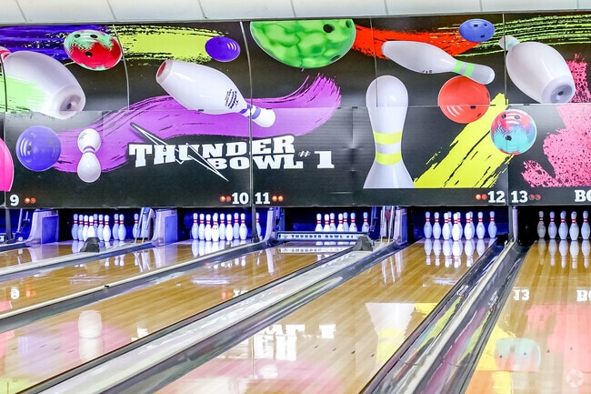 There is a colorful interior and flashing lights at Thunderbowl in South Suburban.