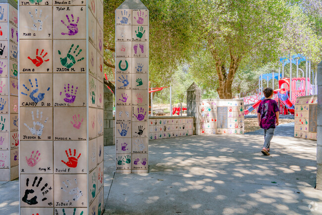 The entrance of Kids Kingdom in Alta Mesa is lined with children handprints.