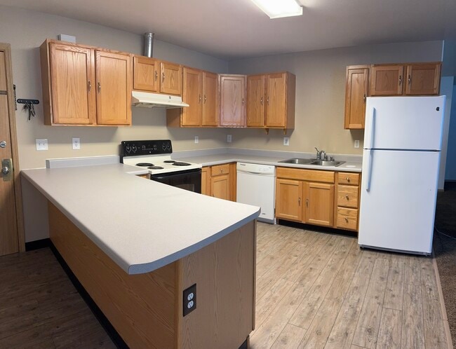 Bright and open kitchen featuring wraparound countertops, full-size appliances