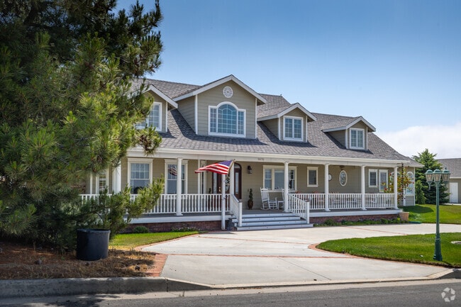 This large Cherry Valley home features a wide front porch for relaxation.
