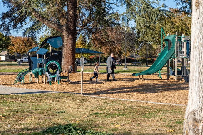 A family strolls through the playground at Mannel Park in Shafter.