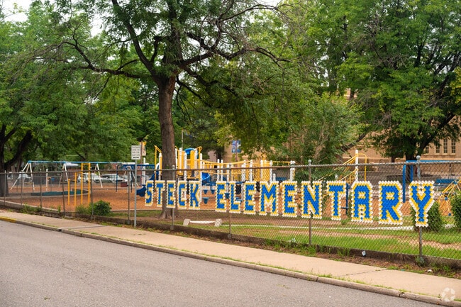 Steck Elementary has a fence sign on the way to the entrancec.
