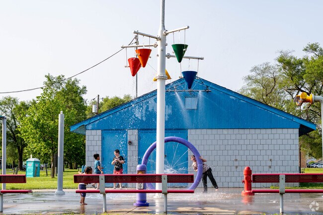 Children enjoy the splash pad at Douglass Park in the Douglass neighborhood.