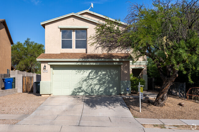 Stucco homes in Dietz offer two-car garages and small plots of land.