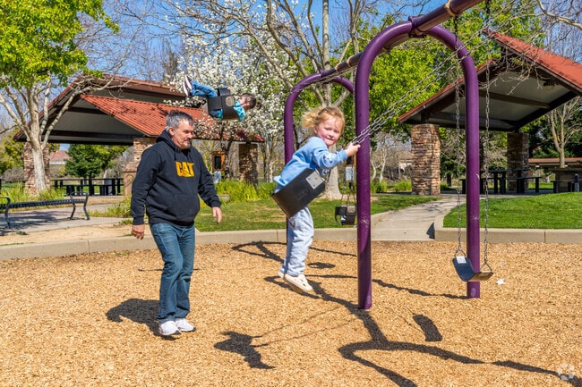 Families rush to the playground at Stone Creek Community Park on sunny days.