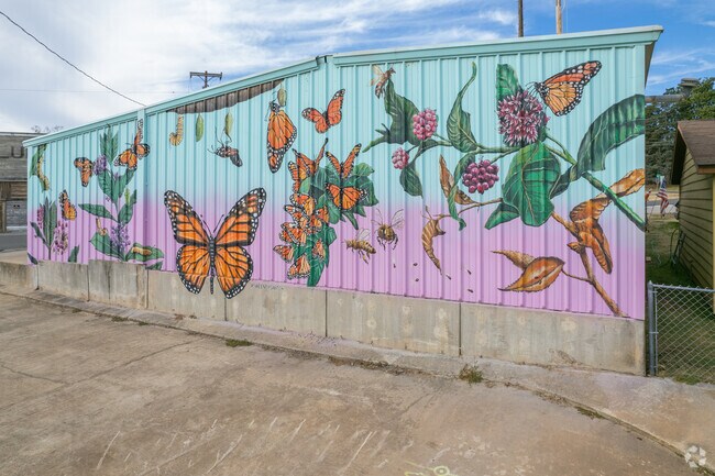 This mural in downtown Harrah is next to the community garden that has a wide variety of plants.