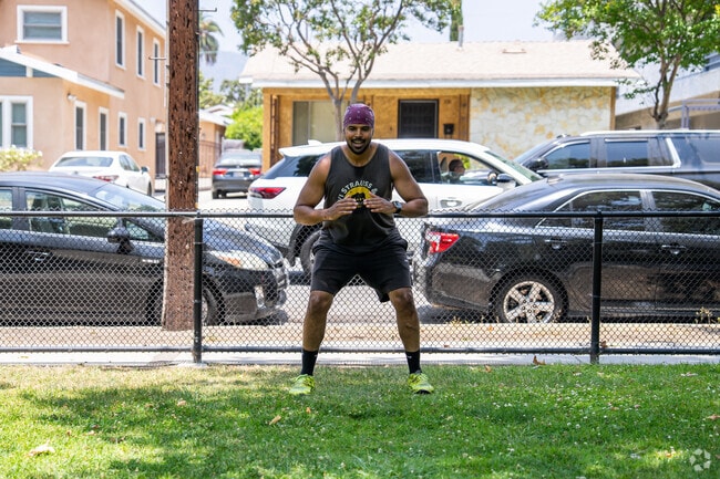 A man starts his morning calisthenics routine at Maple Park.