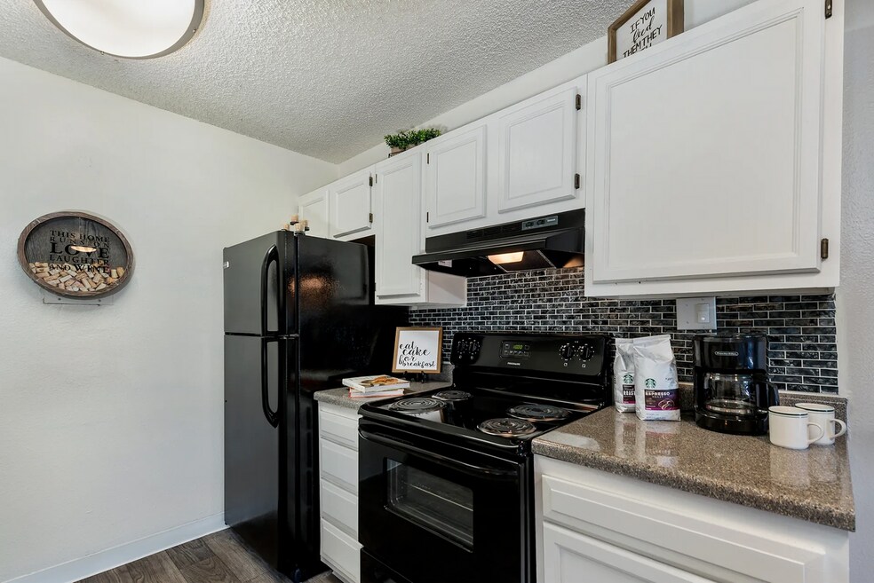 Kitchen w/ White Cabinetry