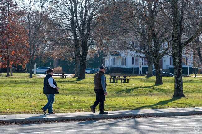 A man and woman walk along East Main Street West Brookfield.