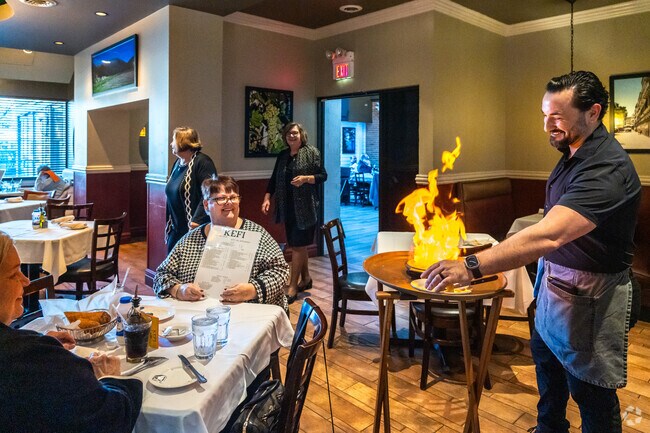Guests enjoy the show when the waiter lights up the saganaki at Kefi near Lake Katherine.