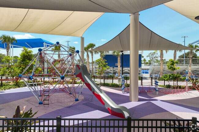 Children enjoy playing on the shaded playground at McNair Park in Collier City.