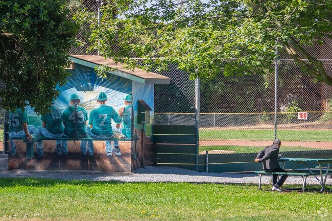 A man stretches at Sorensdale Park, taking in the fresh air and calm surroundings.