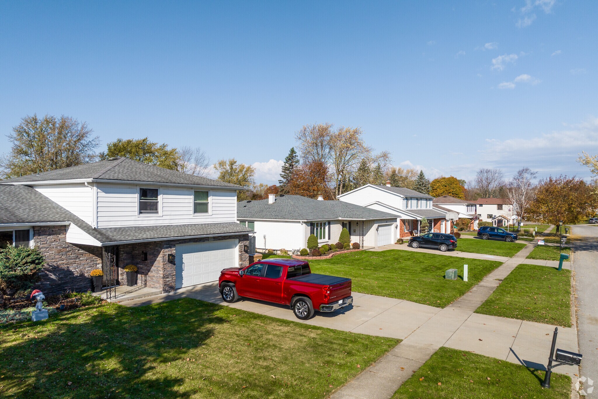 A row of beautiful homes in Bellevue features well-manicured lawns and clean sidewalks.