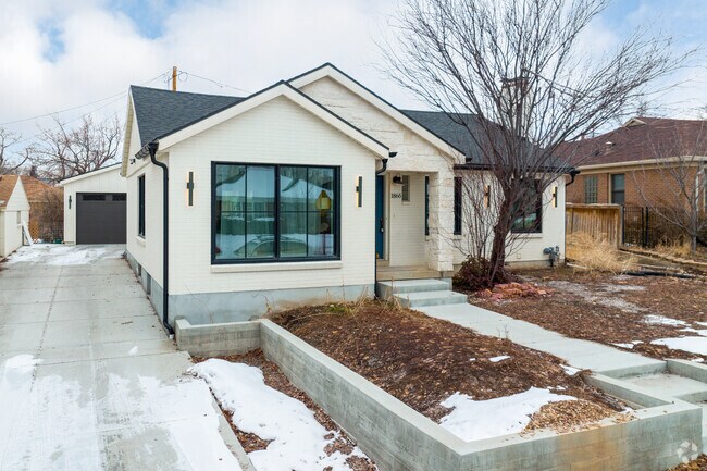 White brick home with long driveway in Bonneville Hills.