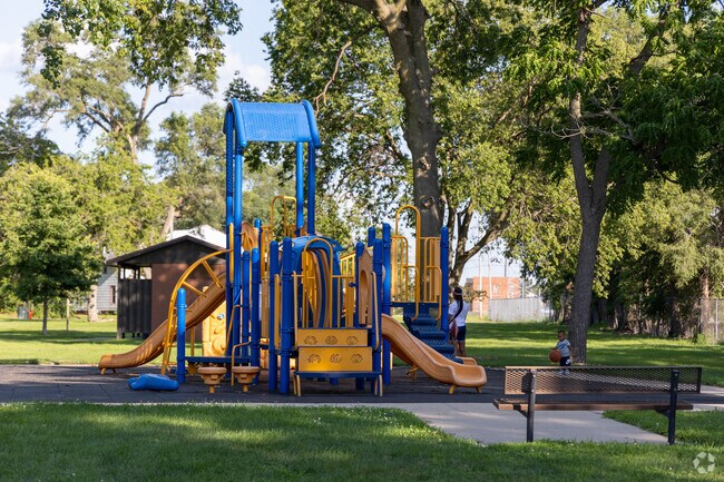 Sullivan Memorial Park features a tree shaded playground for parents and children to play.