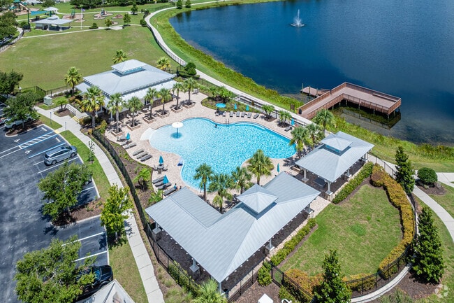 In the center of the Long Lake Ranch neighborhood of Florida is a resort-style pool with a water fountain and lakeside views.