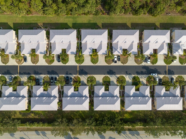 The Cockellshell Village two story attached villas in the Council section of Bonita Springs has classic symmetrical styling,