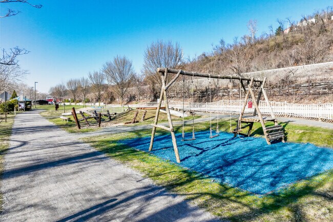 Millvale Riverfront Park includes swings and green space for outdoor fun.