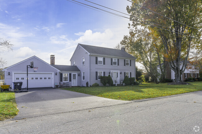 A cluster of colonial homes sits near the picturesque Arnold Mills Reservoir.