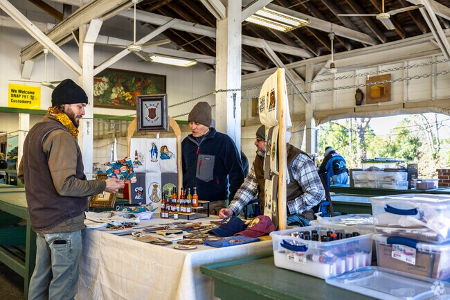 Vendor at the Farmers Market sell homemade crafts, fresh produce, meats, and honey.