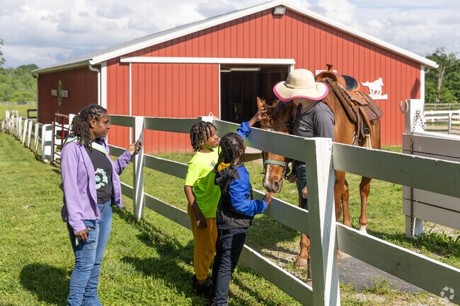 These Winton Lake children have fun experiencing a little farm life.