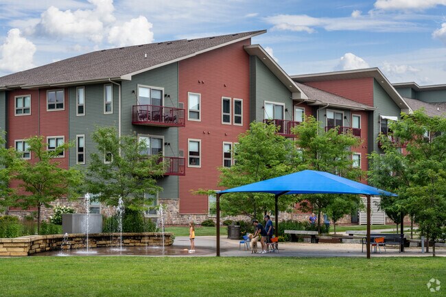 Families enjoy the splash pad at River Prairie Park.
