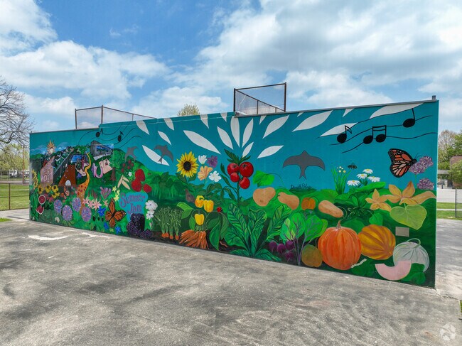 The Fantastic Food Garden Mural includes imagery of flowers, fruits, vegetables, honeybees and monarch butterflies.