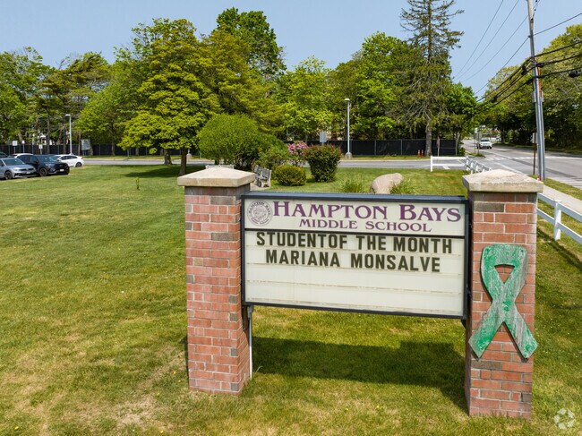 The student of the month is congratulated at Hampton Bays Middle School.