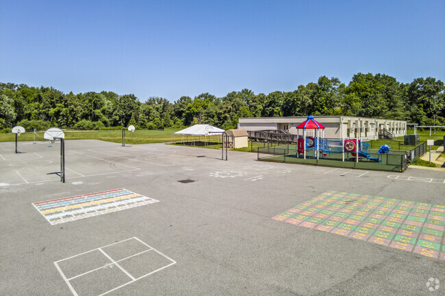 Basketball courts and a playground area reside behind the Riverside Elementary School.