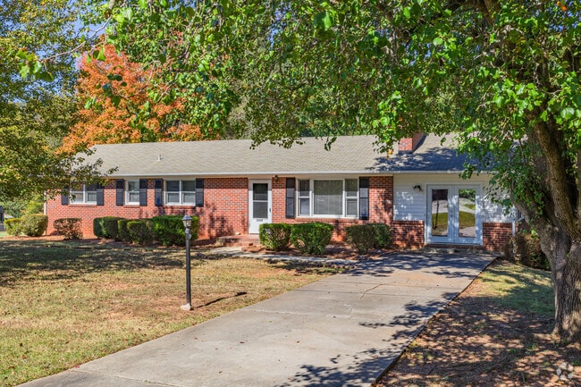 In Salem Woods, a brick ranch-style house sits comfortably in the shade.