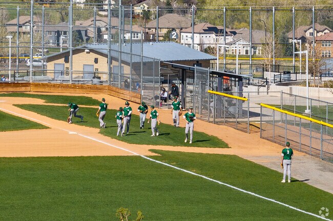 Baseball games take place on summer afternoons at Long Lake Regional Park in Arvada.
