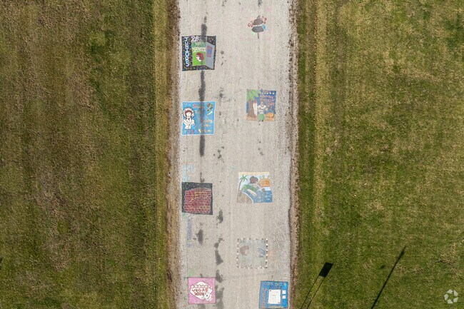 Seniors draw on the road outside Pittsfield High School to celebrate graduation.