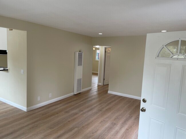 Living room with dimmable recessed lighting and wall heater