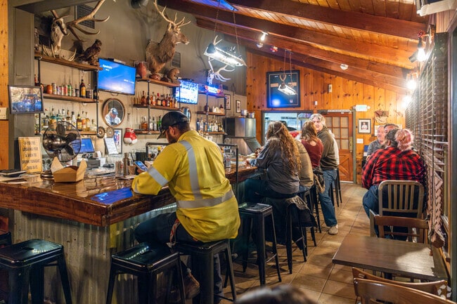 Customers line up at the bar at Salt Lick Tavern in Lake Elizabeth.