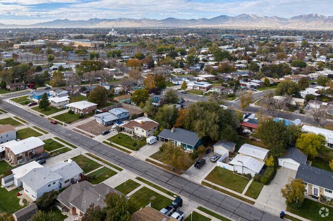 Aerial view shows well spaced homes in Redwood, an LDS temple and the mountains in the distance.