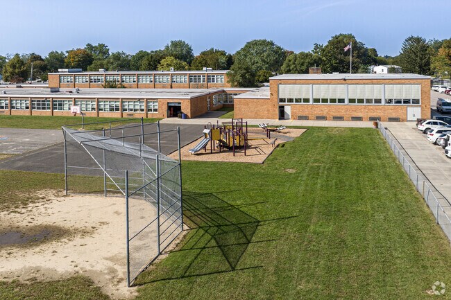 The back field has a secondary playground and softball field.