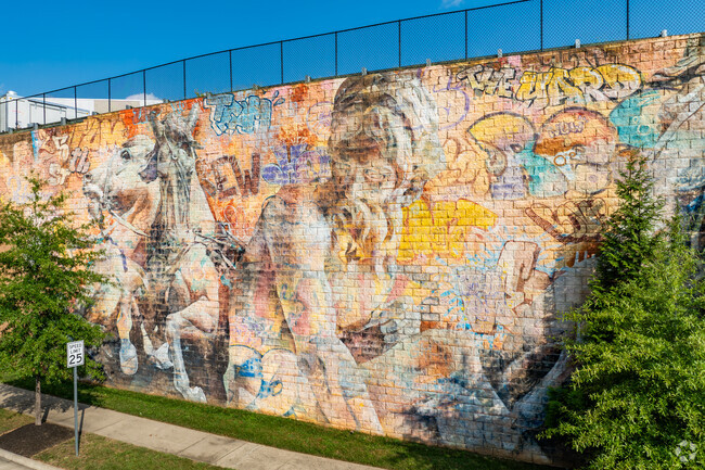 Artists Avo and Pichi painted a mural that welcomes you to the 5th Street Station shopping area.