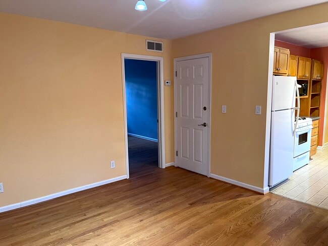 Living/Dining room facing entry and bedroom doors