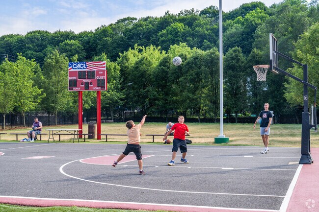 Kids and adults shoot hoops at Barefield Recreation Complex.