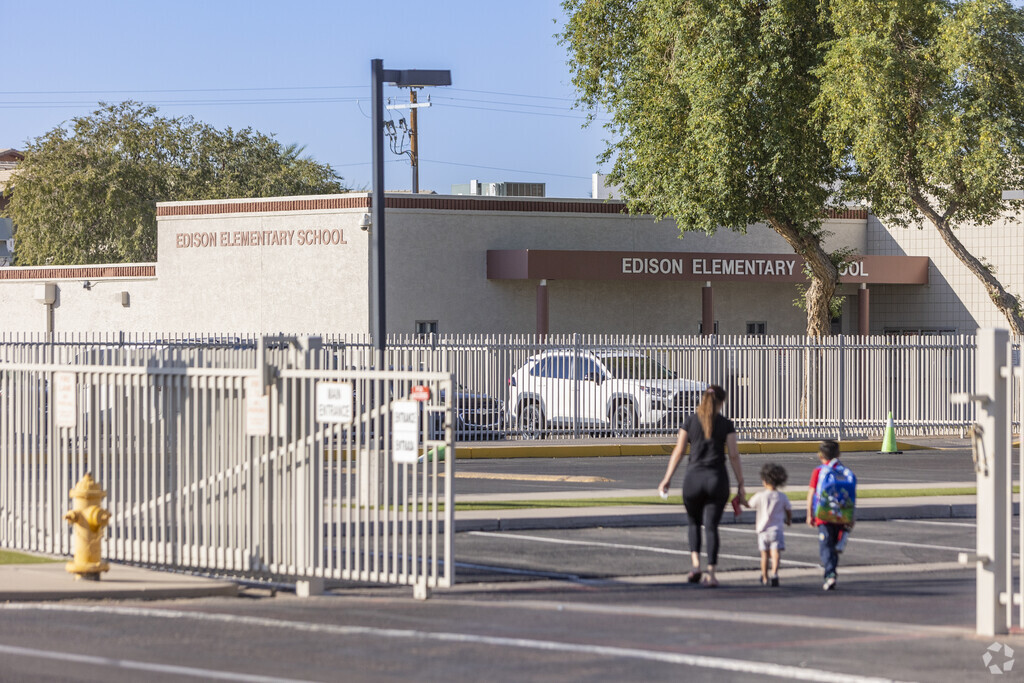 A parent walks her kids to Edison Elementary School in Phoenix.